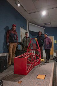 WSU Vancouver’s Formula VanCougs standing with their demo chassis.