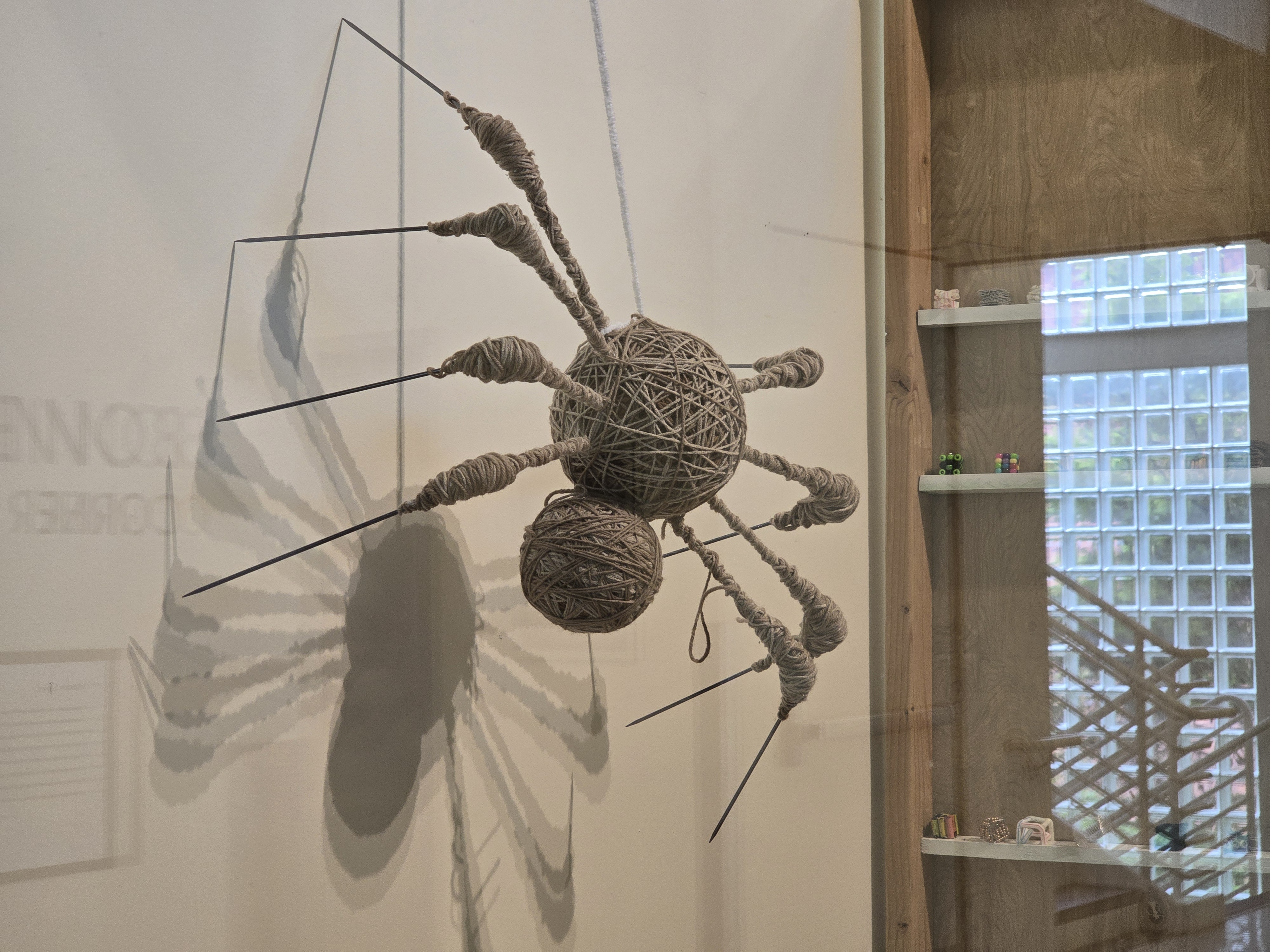 The biggest of the woven spiders with its imposing needle legs, hangs against the wall in the Bowie Corner of the Multimedia Classroom Building. (Photo courtesy of Jaret Benson)