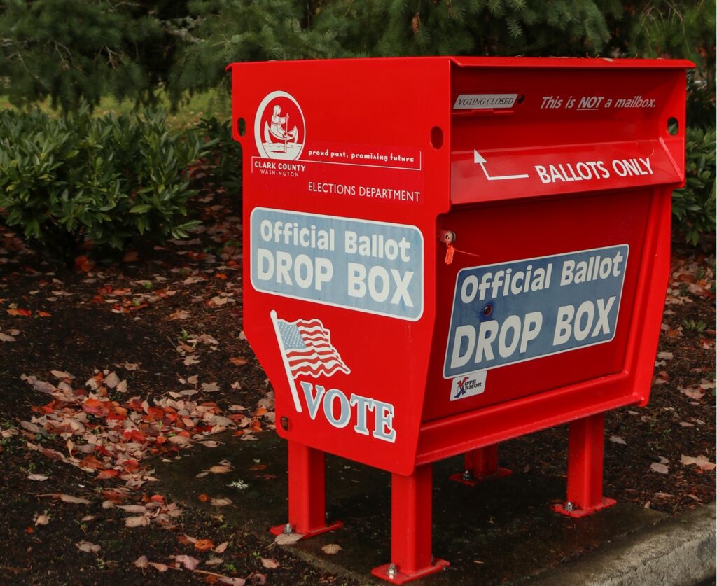 A red ballot drop box.