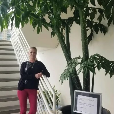 Dawn Freeman, standing next to Titan, WSU-V's corpse flower. (Pip Swinger / The VanCougar)