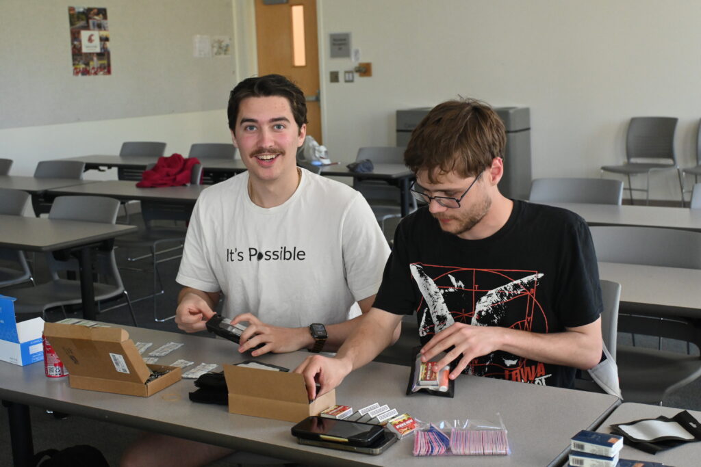 A Photo showing Washington State University students Aidan and Elijah making care kits.