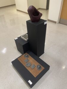 Photo shows a couple sculptures sitting in the middle of the gallery, including the "Time Passes" sculpture. Photo taken by Jonah Barnett.