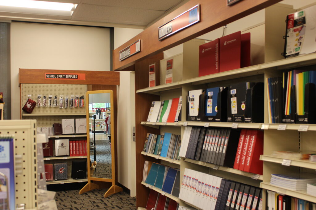 Image contains photo displaying shelves of textbooks at the bookstore for Washington State University Vancouver. Photo taken by Will Legg from The Vancougar.