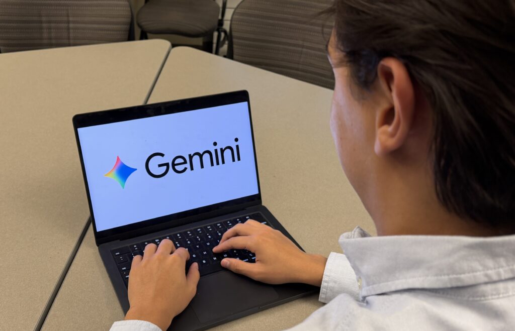 Image of student working on laptop displaying Google Gemini logo (Ashlynn Fredendall / VanCougar)