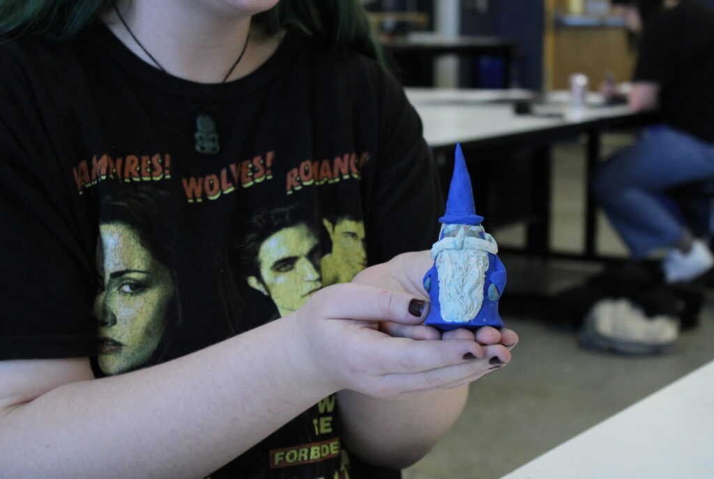 An attendee shows off their clay sculpture during the ArtX event, “Sculpted by You”