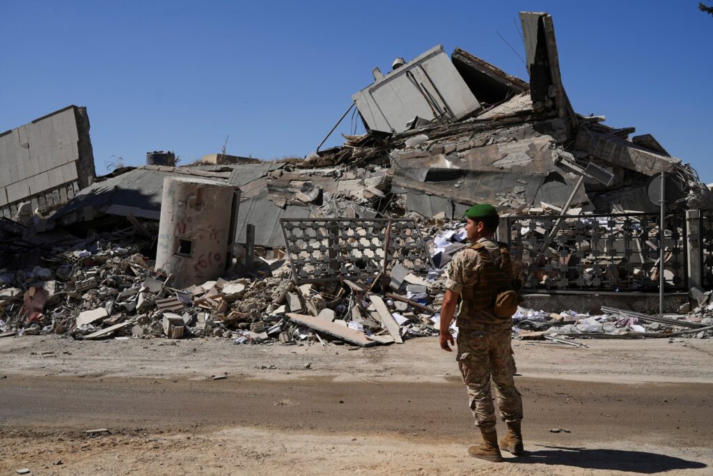 Image of soldier standing in front of rubble (Courtesy of World Economic Forum)