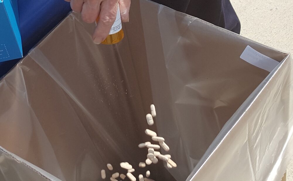 Image of a hand pouring medication into a box (Courtesy of the United States Drug Enforcement Administration)